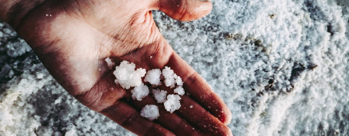 Man holding sea salt in his hand for adding salt to your Aquaponics System